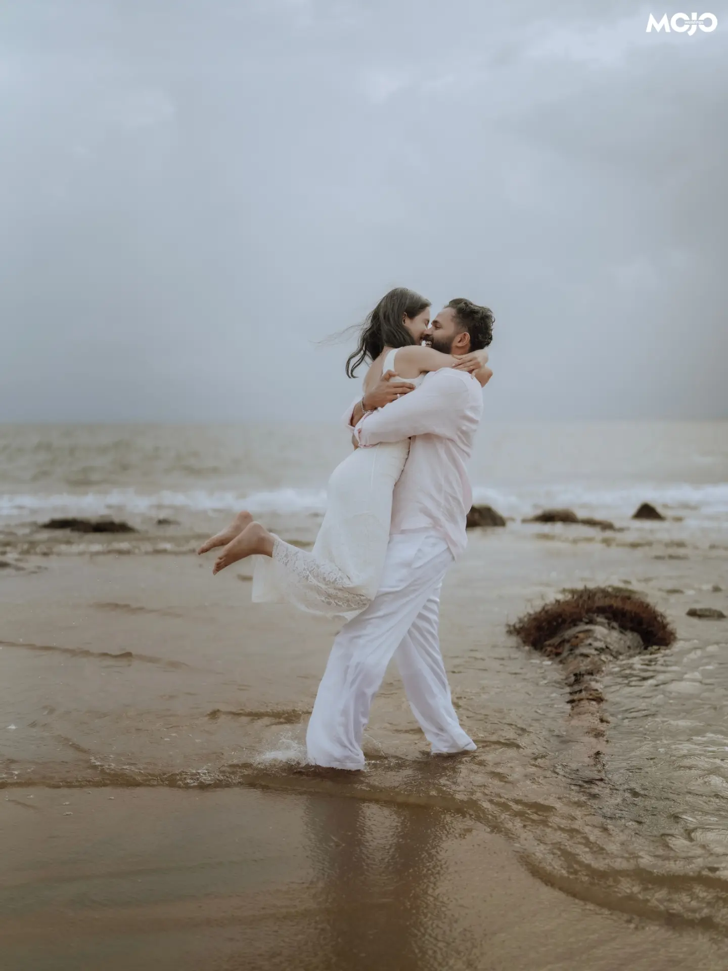 A couple embracing together at the beach