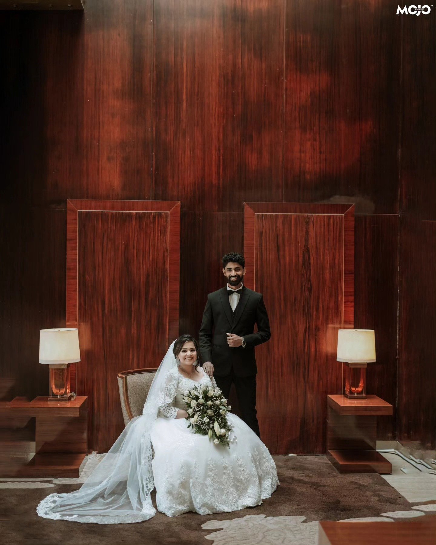 A bride and groom posing together after their ceremony